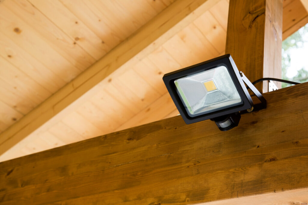 led projector with motion sensor in wooden outdoor carport